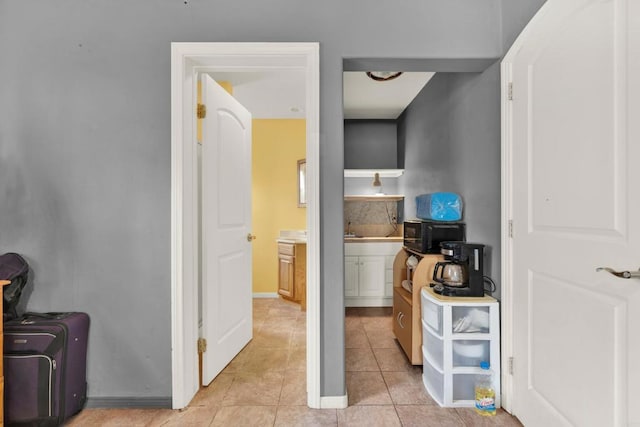 corridor featuring light tile patterned flooring