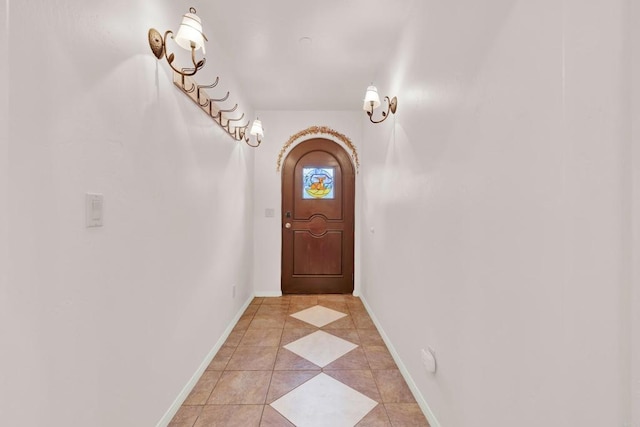 doorway with light tile patterned floors