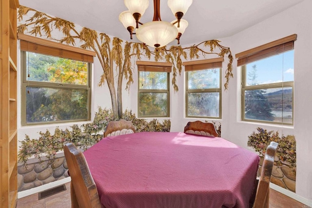 dining area with a healthy amount of sunlight and a notable chandelier