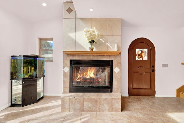 interior space featuring a tile fireplace and light tile patterned floors