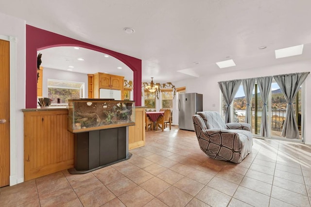 interior space featuring light tile patterned floors and a notable chandelier