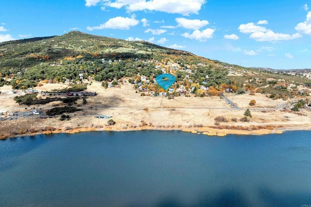 drone / aerial view with a water and mountain view