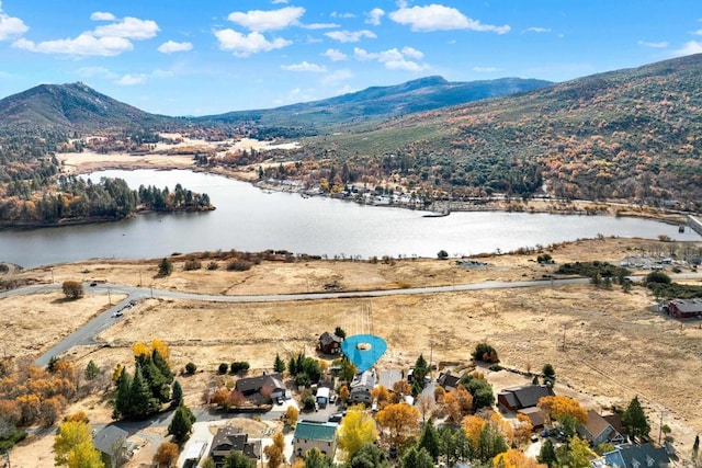 drone / aerial view with a water and mountain view