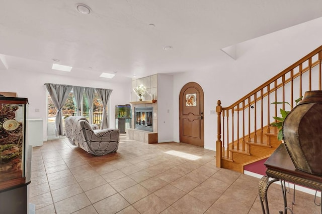 34667 Navajo Rd, Julian, CA 92036 - living area featuring light tile patterned floors, stairway, and a tile fireplace