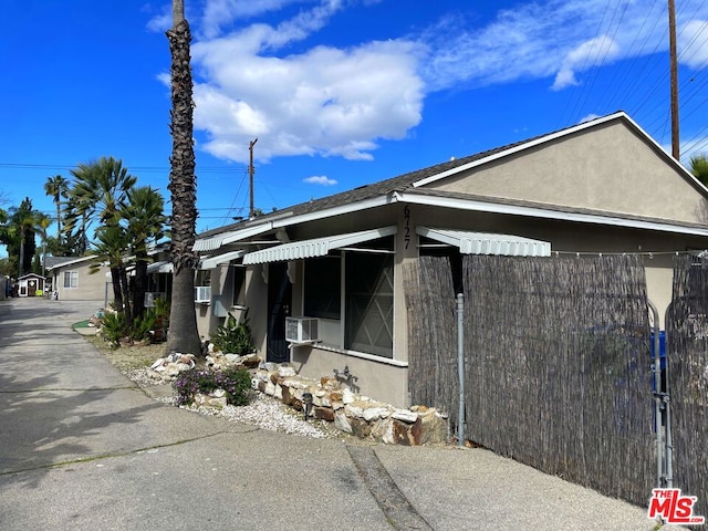 view of side of property with cooling unit