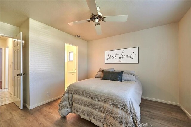 bedroom featuring hardwood / wood-style floors, ceiling fan, and ensuite bathroom