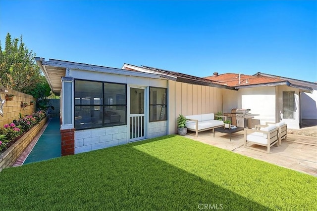 back of house featuring an outdoor hangout area, a lawn, a patio area, and a sunroom