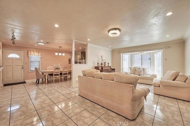 tiled living room featuring a textured ceiling and crown molding