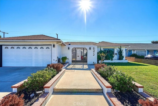 single story home featuring a garage and a front yard