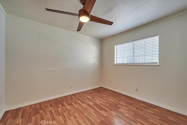 unfurnished room with ceiling fan, light hardwood / wood-style flooring, a textured ceiling, and ornamental molding