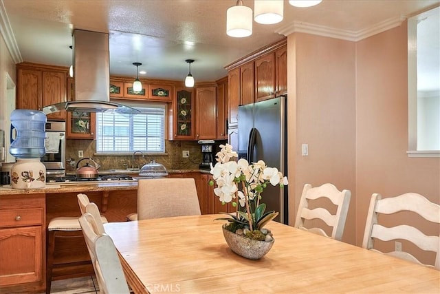 dining room featuring ornamental molding and sink