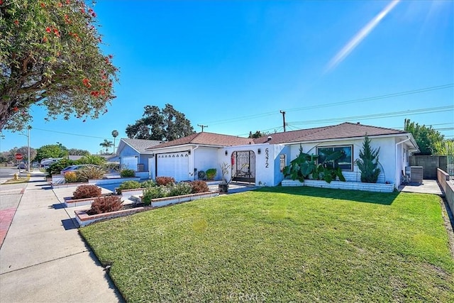 ranch-style home featuring cooling unit, a front yard, and a garage