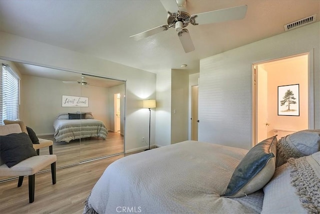 bedroom featuring ceiling fan, light hardwood / wood-style floors, and a closet