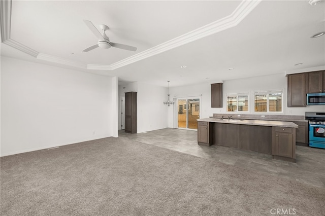 kitchen with hanging light fixtures, stainless steel appliances, crown molding, a tray ceiling, and ceiling fan with notable chandelier