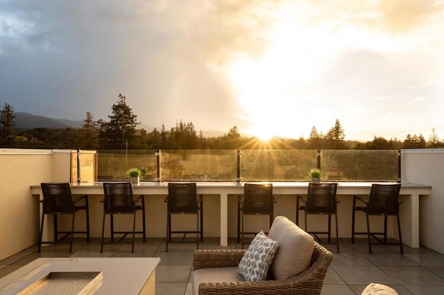 patio terrace at dusk featuring exterior bar