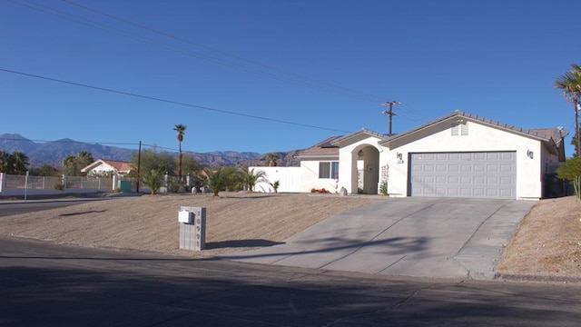 ranch-style house with a mountain view and a garage