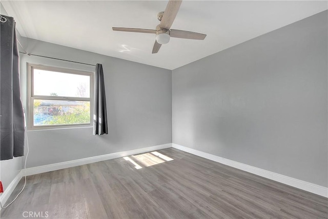 empty room featuring ceiling fan and wood-type flooring