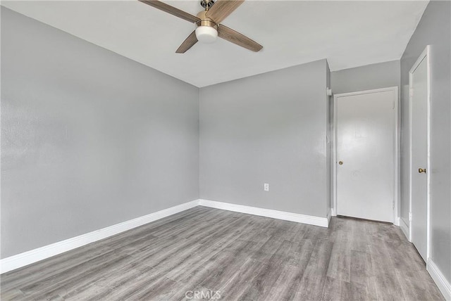 empty room with ceiling fan and light wood-type flooring