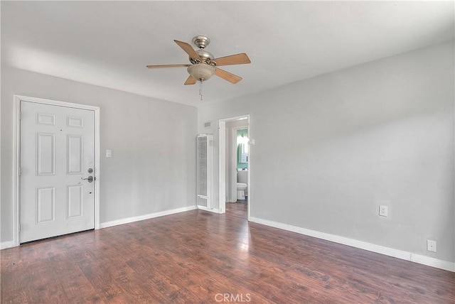 spare room featuring ceiling fan and dark hardwood / wood-style flooring