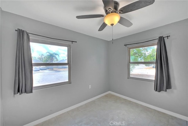 spare room with plenty of natural light and ceiling fan