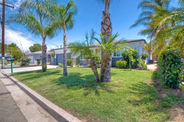 view of front of home with a front yard and a garage