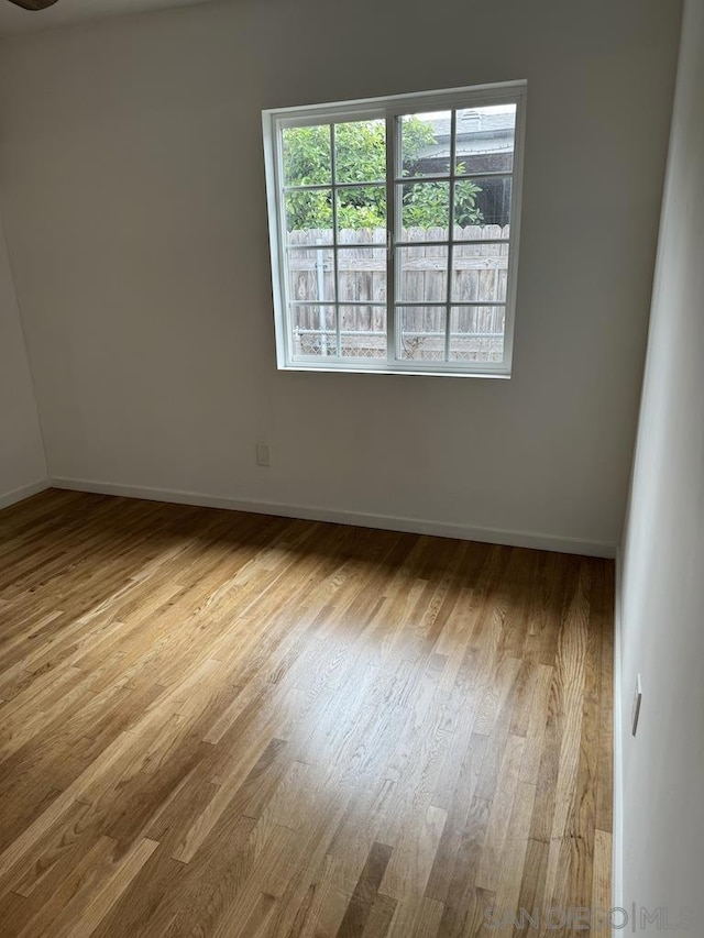 unfurnished room with light wood-type flooring