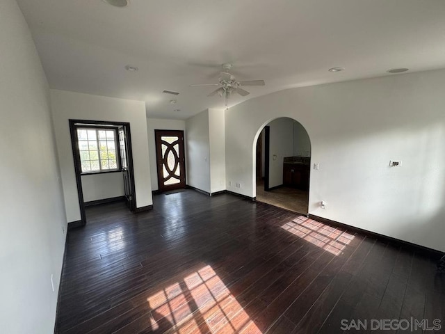 unfurnished room with dark hardwood / wood-style flooring and ceiling fan