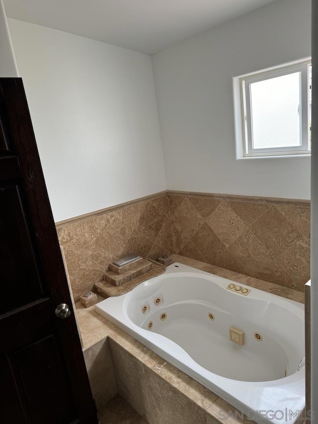 bathroom featuring a relaxing tiled tub