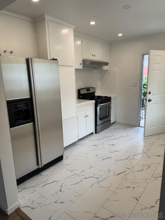 kitchen with white cabinets, crown molding, and stainless steel appliances