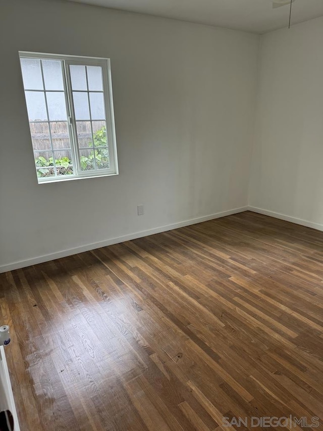 unfurnished room featuring dark hardwood / wood-style floors