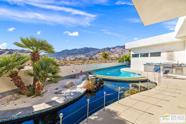 view of swimming pool featuring a grill and a mountain view