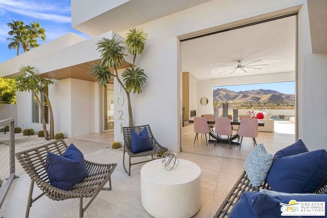 view of patio featuring a mountain view and ceiling fan