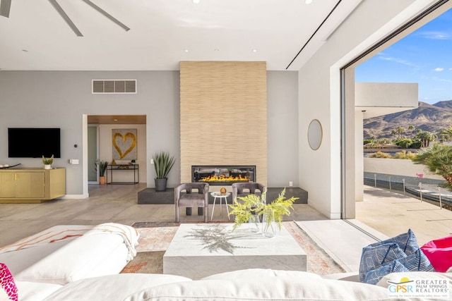 living room featuring a mountain view and a large fireplace