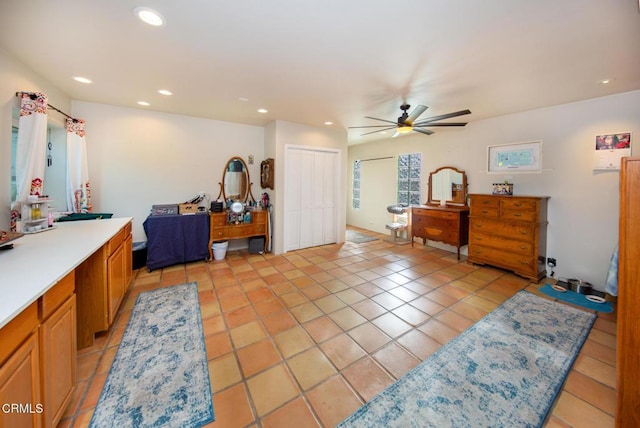 tiled bedroom featuring ceiling fan