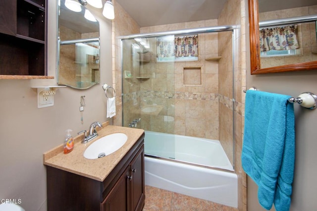 bathroom with tile patterned floors, vanity, and enclosed tub / shower combo