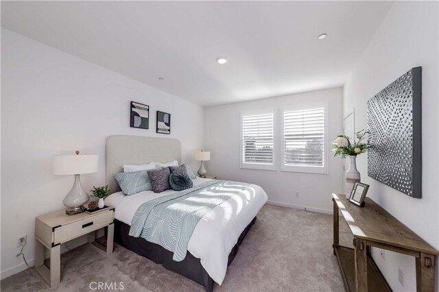 bedroom featuring light colored carpet