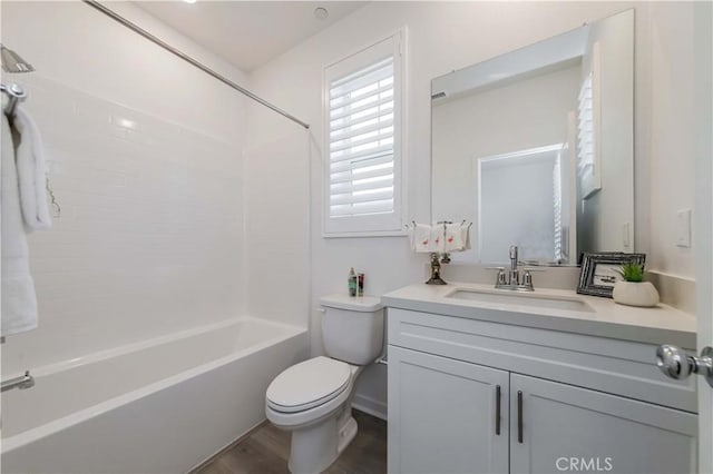 full bath with toilet, shower / washtub combination, wood finished floors, and vanity