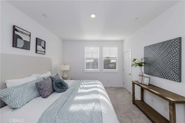 bedroom featuring light carpet