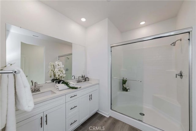 bathroom featuring a stall shower and a sink