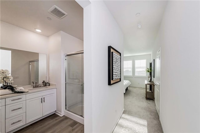 bathroom featuring a stall shower, baseboards, visible vents, and vanity