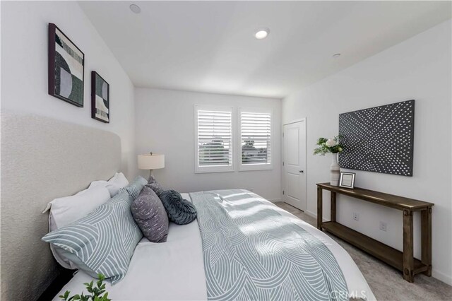 bedroom featuring light carpet