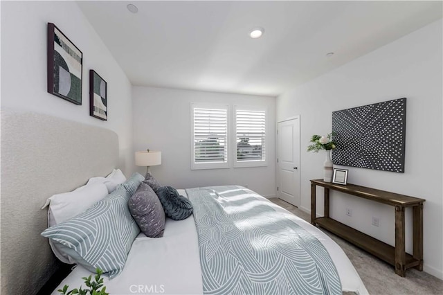 bedroom with light carpet and baseboards