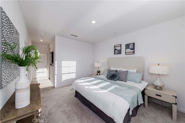 carpeted bedroom featuring baseboards, visible vents, and recessed lighting