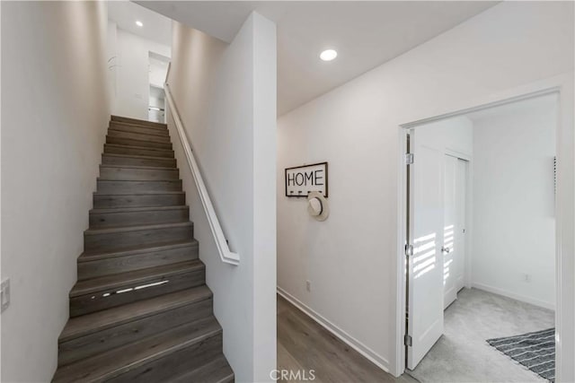 stairway featuring baseboards and recessed lighting