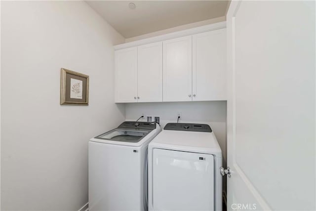 laundry area with washer and dryer and cabinet space