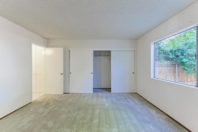 unfurnished bedroom featuring multiple windows and light colored carpet