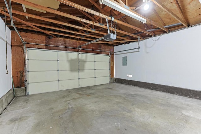 garage with electric panel and a garage door opener