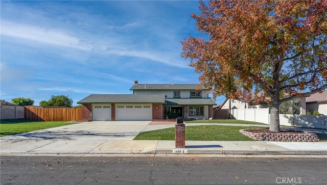 view of front facade with a garage and a front lawn