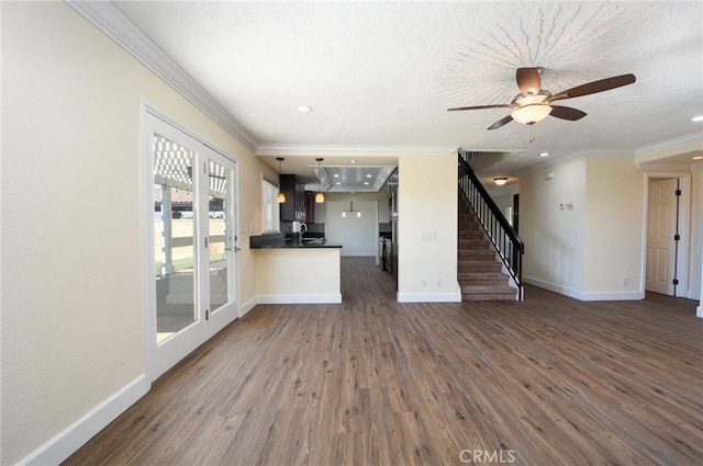 unfurnished living room featuring sink, ceiling fan, dark hardwood / wood-style flooring, and crown molding