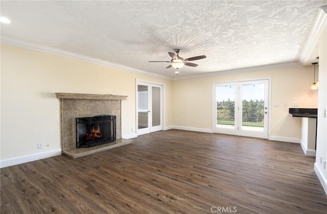 unfurnished living room with ornamental molding, dark wood-type flooring, and a tile fireplace